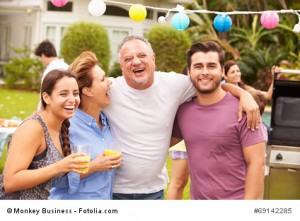 Parent With Adult Children Enjoying Party In Garden