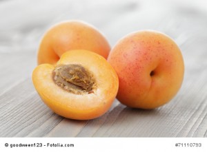 ripe juicy apricots on wooden table